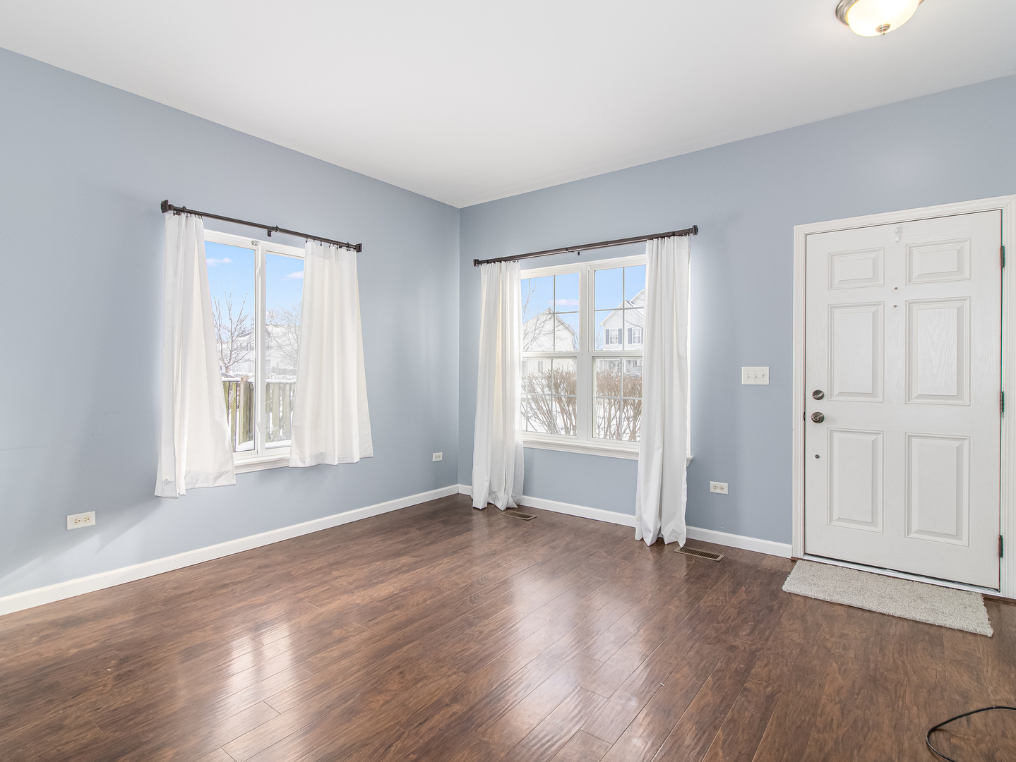 2817 Hoffman Street Plano, IL 60545 - Photo 11 of 25 a view of an empty room with wooden floor and a window