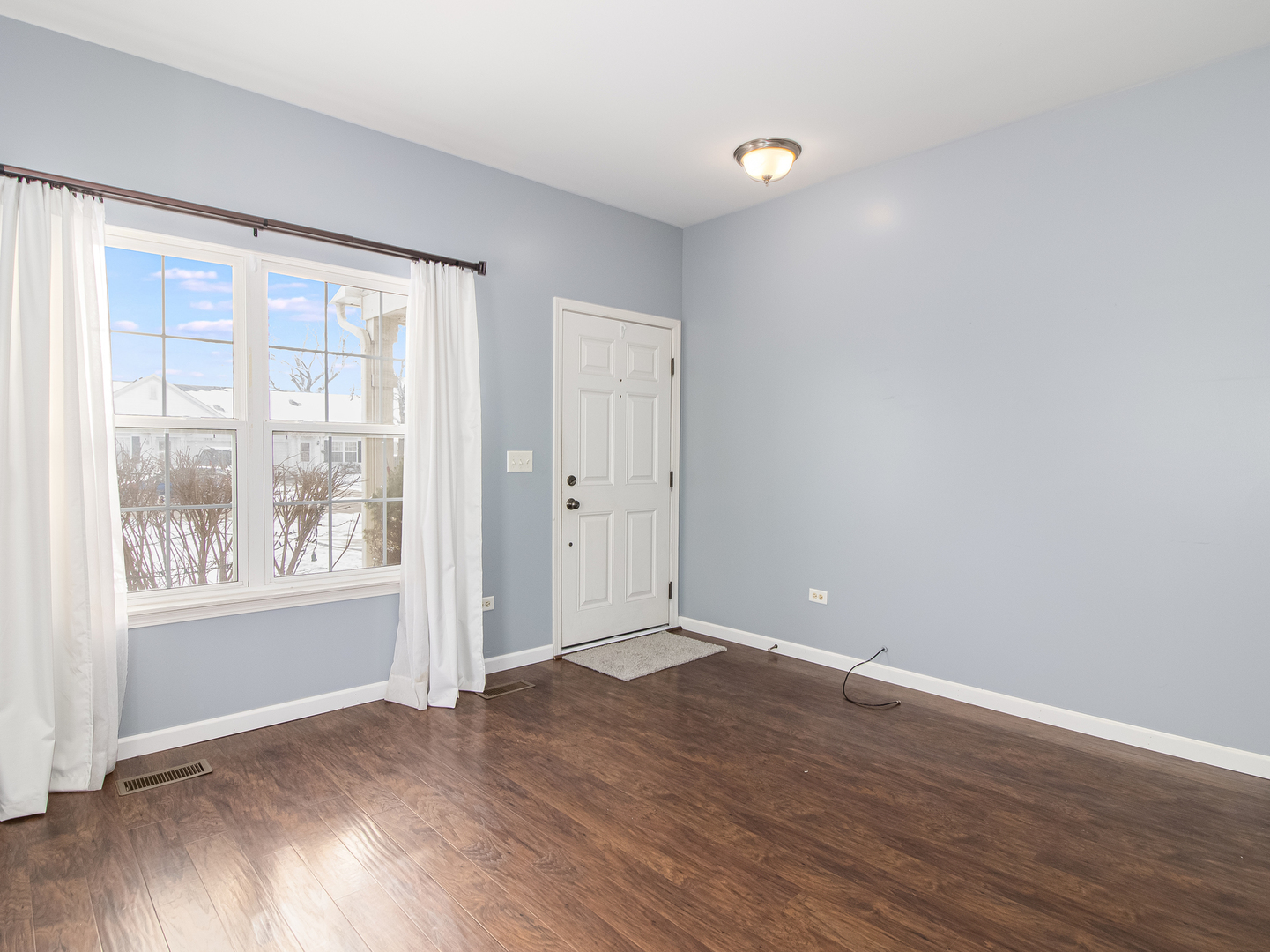 2817 Hoffman Street Plano, IL 60545 - Photo 12 of 25 an empty room with wooden floor and windows