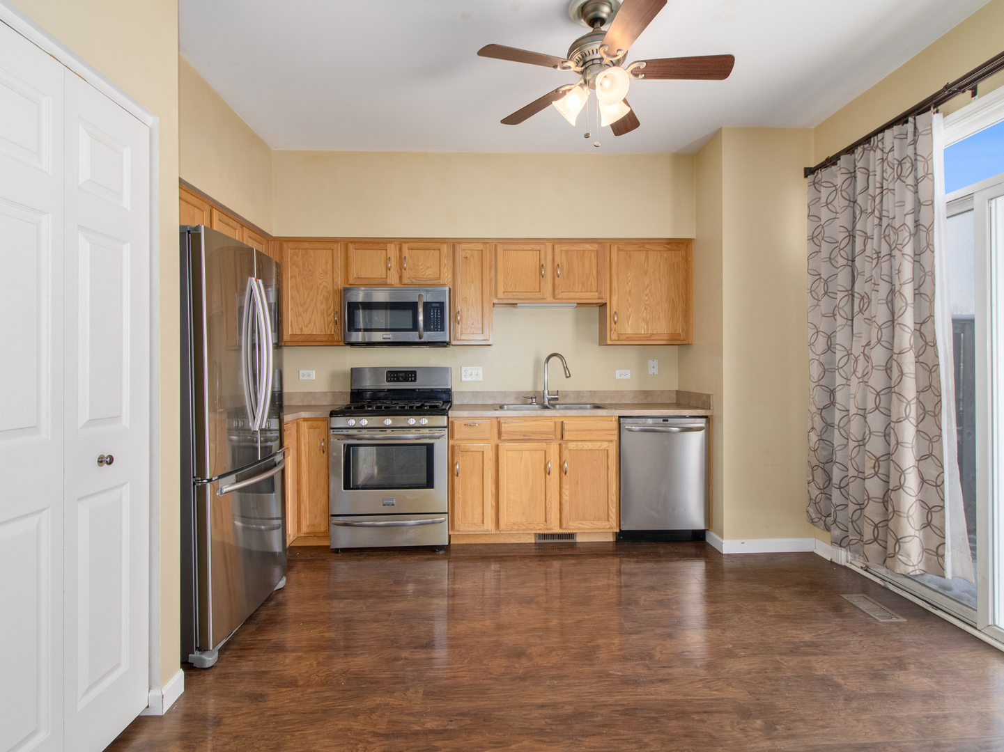 2817 Hoffman Street Plano, IL 60545 - Photo 8 of 25 a kitchen with stainless steel appliances a stove a sink and a refrigerator