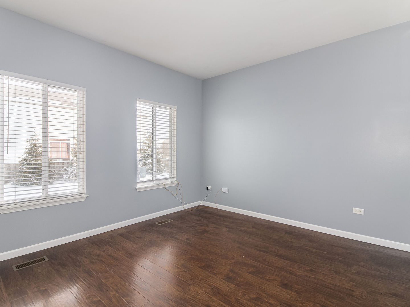 2817 Hoffman Street Plano, IL 60545 - Photo 10 of 25 a view of an empty room with wooden floor and a window