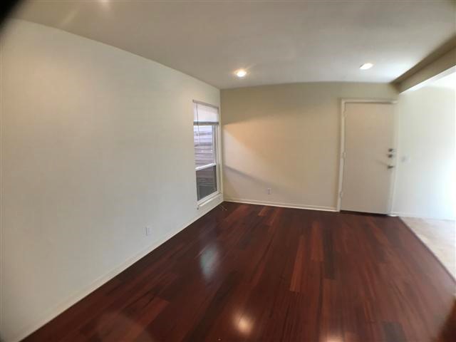 2800 Cole Street, Unit 206C Austin, TX 78705 - Photo 7 of 12 a view of an empty room with wooden floor