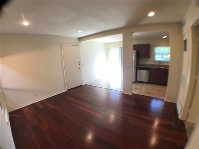 2800 Cole Street, Unit 206C Austin, TX 78705 - Photo 8 of 12 an empty room with wooden floor and windows