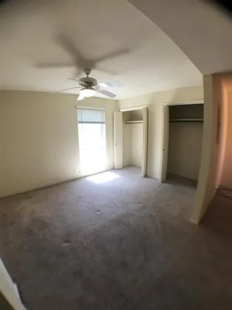 an empty room with a empty space and windows