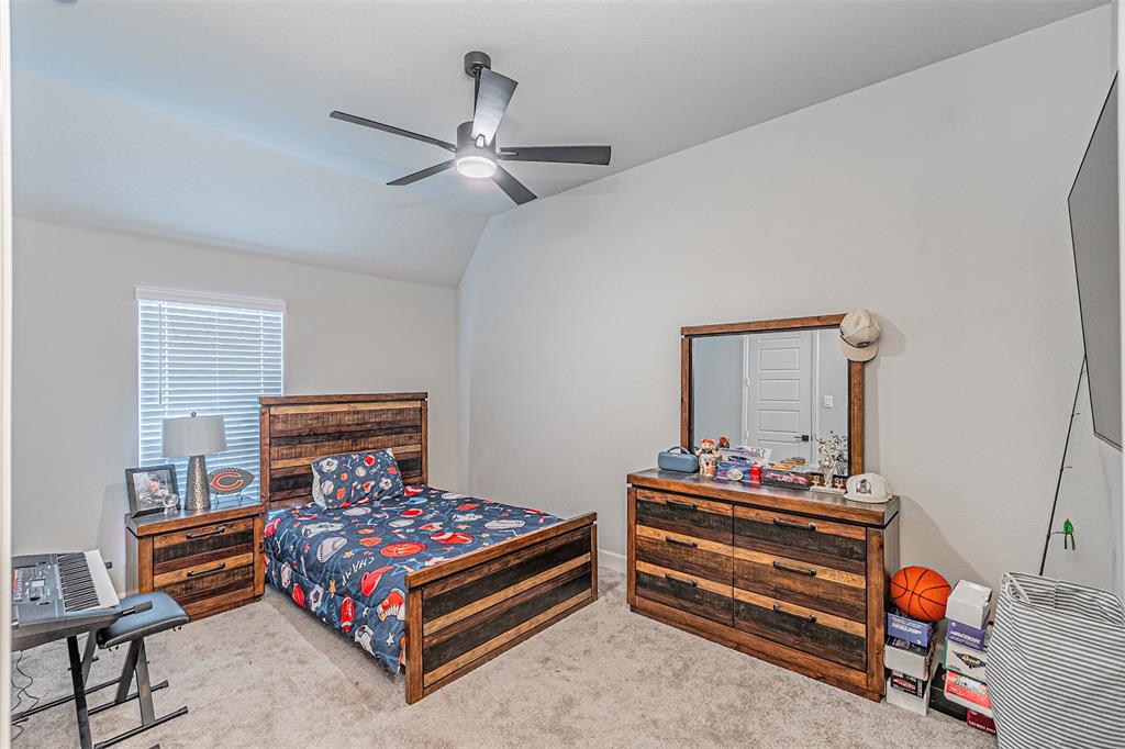 116 Derrett Lane Rhome, TX 76078 - Photo 18 of 30 a bedroom with a bed and wooden floor