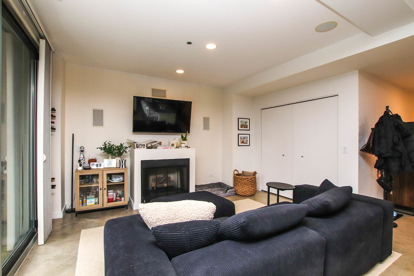 156 West Superior Street, Unit 302 Chicago, IL 60654 - Photo 11 of 17 a living room with furniture a fireplace and a flat screen tv