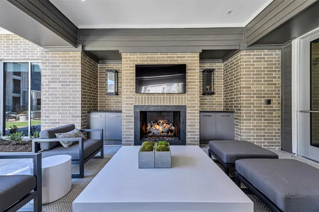 a living room with furniture flat screen tv and a fireplace