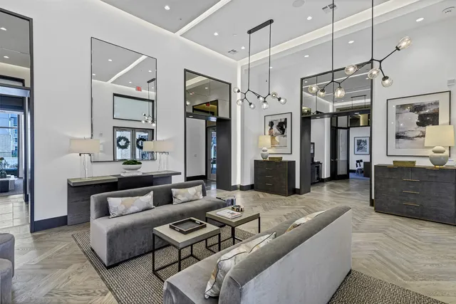 a living room with furniture and a kitchen view