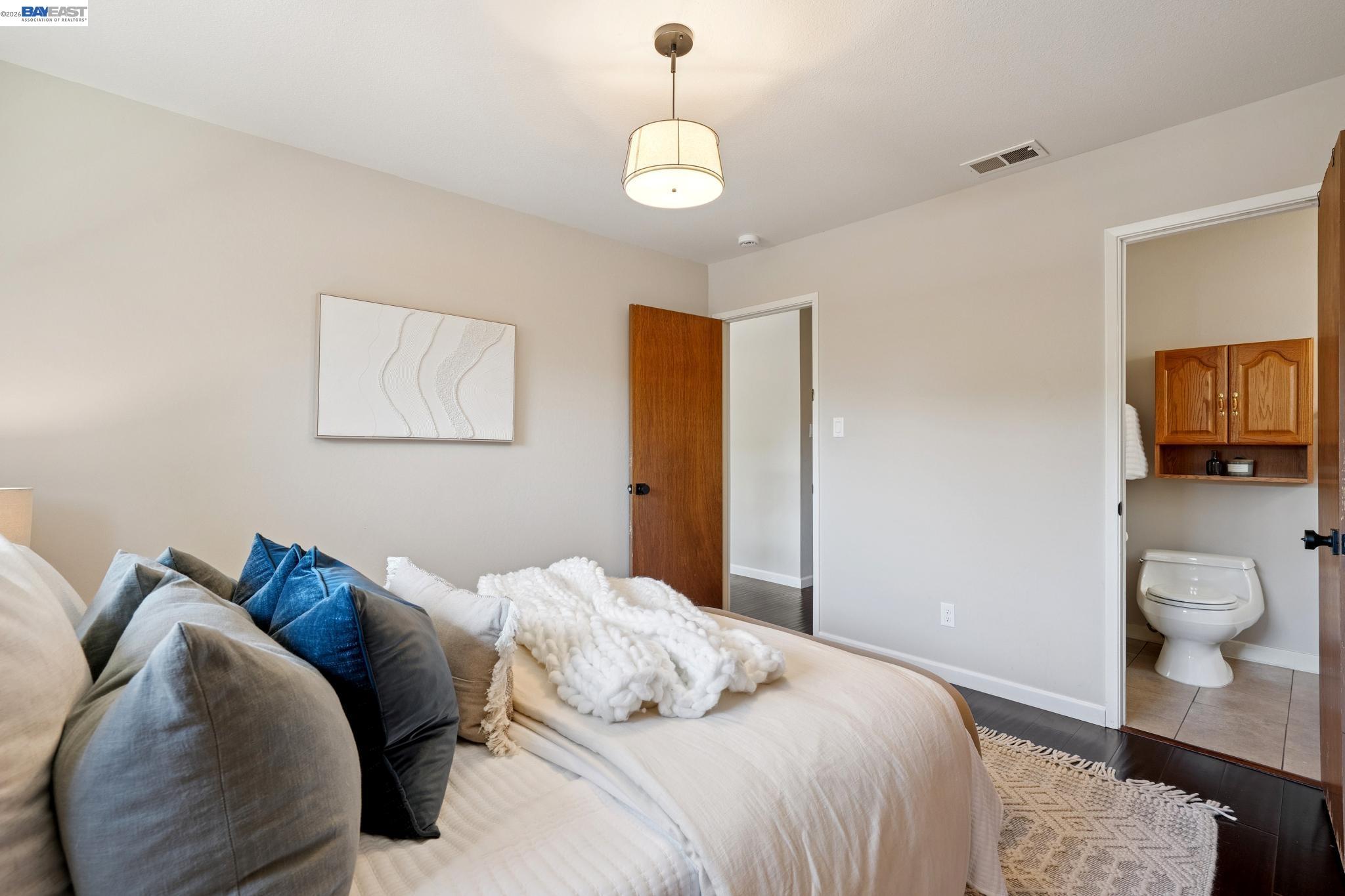 328 Sand Beach Road Alameda, CA 94501 - Photo 27 of 48 a bedroom with a bed and a chandelier