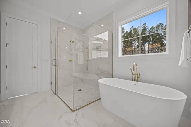 a bathroom with a toilet a sink a mirror and bathtub