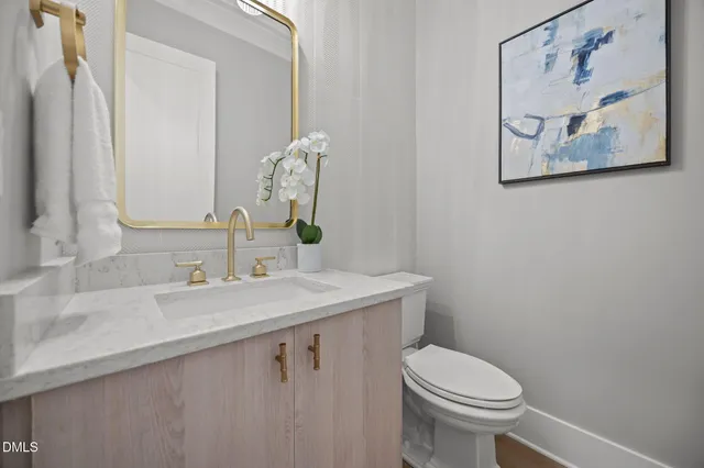 a view of a white house with a big yard and large trees