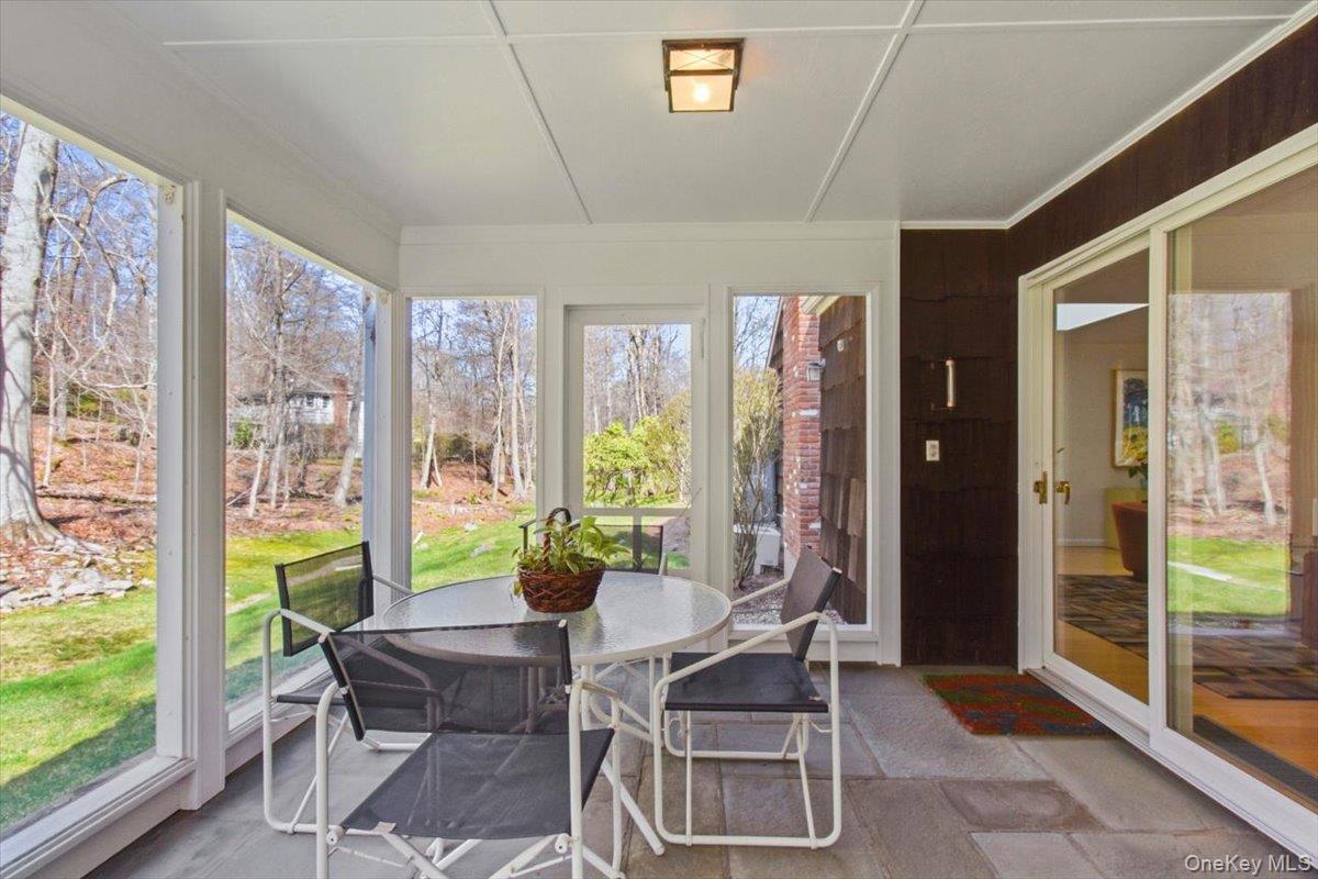 73 Cedar Hill Road Bedford, NY 10506 - Photo 17 of 33 a dining room with furniture and a floor to ceiling window