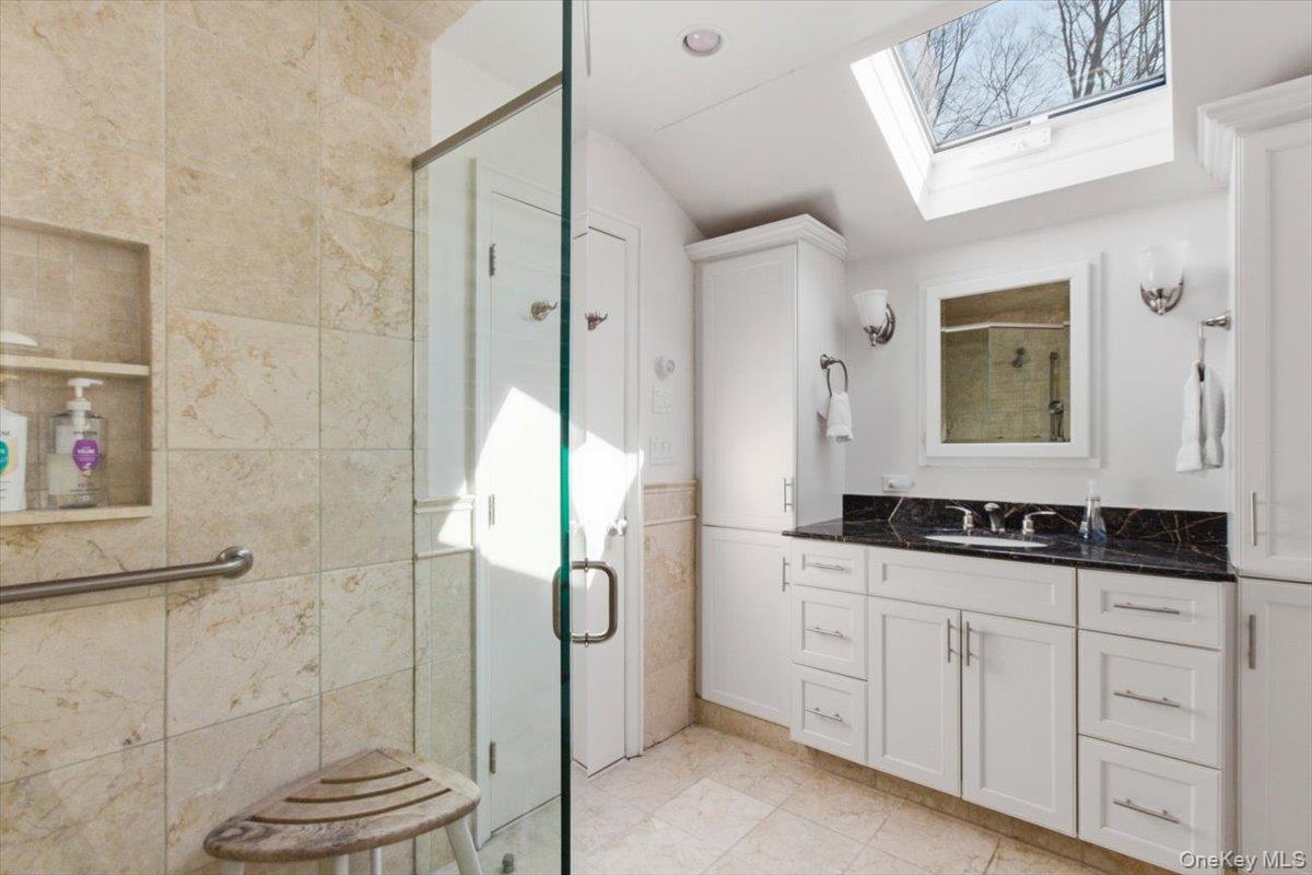 73 Cedar Hill Road Bedford, NY 10506 - Photo 20 of 33 a bathroom with a granite countertop sink a toilet a mirror and shower