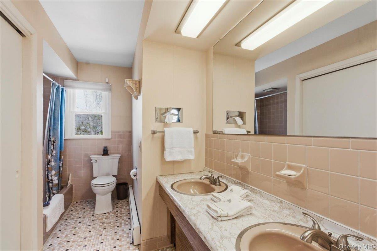 73 Cedar Hill Road Bedford, NY 10506 - Photo 23 of 33 a bathroom with a granite countertop sink a toilet a mirror and shower