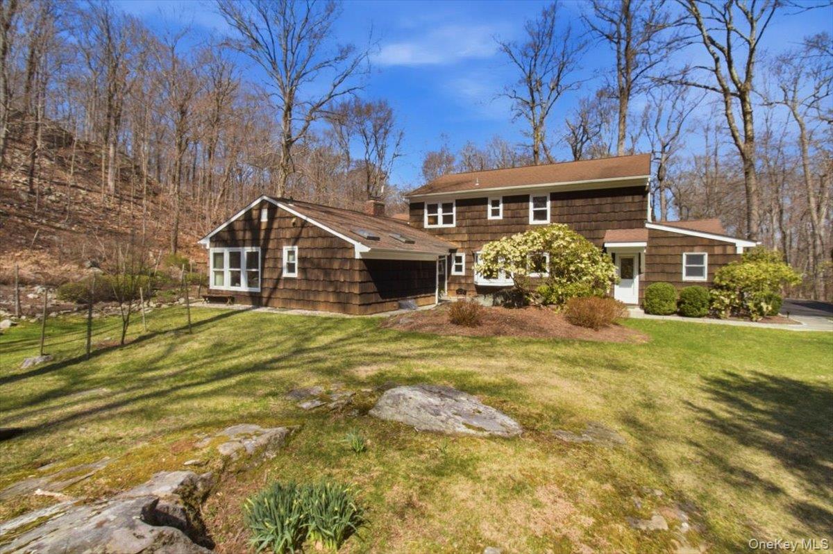 73 Cedar Hill Road Bedford, NY 10506 - Photo 28 of 33 a front view of a house with a garden