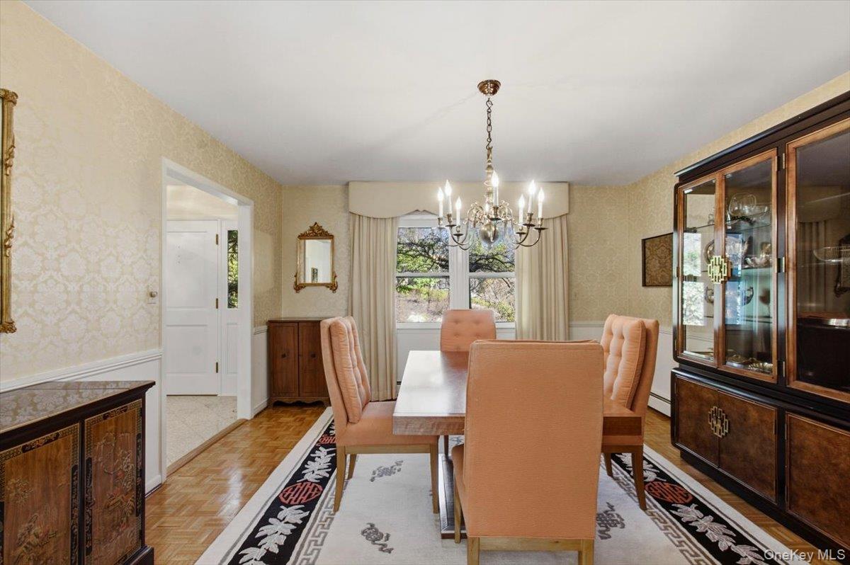 73 Cedar Hill Road Bedford, NY 10506 - Photo 6 of 33 a view of a dining room with furniture a chandelier and wooden floor