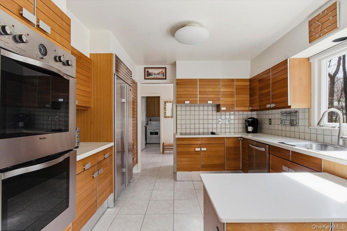 73 Cedar Hill Road Bedford, NY 10506 - Photo 8 of 33 a kitchen with stainless steel appliances granite countertop a stove a sink and a microwave