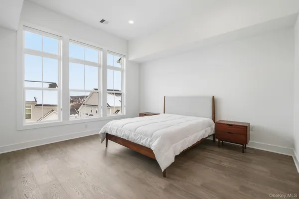 a spacious bedroom with a bed and a large window