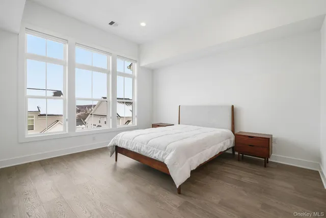 a spacious bedroom with a bed and a large window