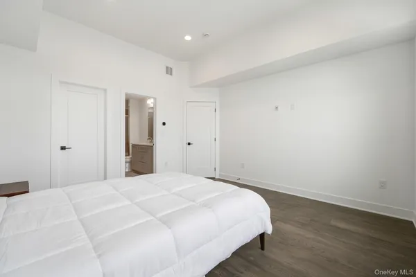 a bedroom with a bed and a night stand