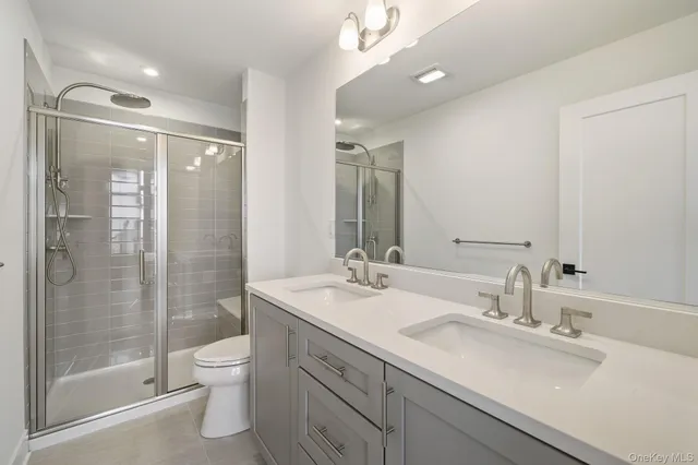 a bathroom with a sink shower and a toilet