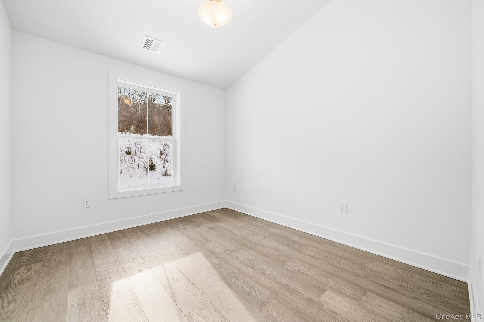 4034 Chestnut Rdg Road, Unit 62 Fishkill, NY 12524 - Photo 27 of 31 Second Bedroom featuring vaulted ceiling and light wood-type flooring