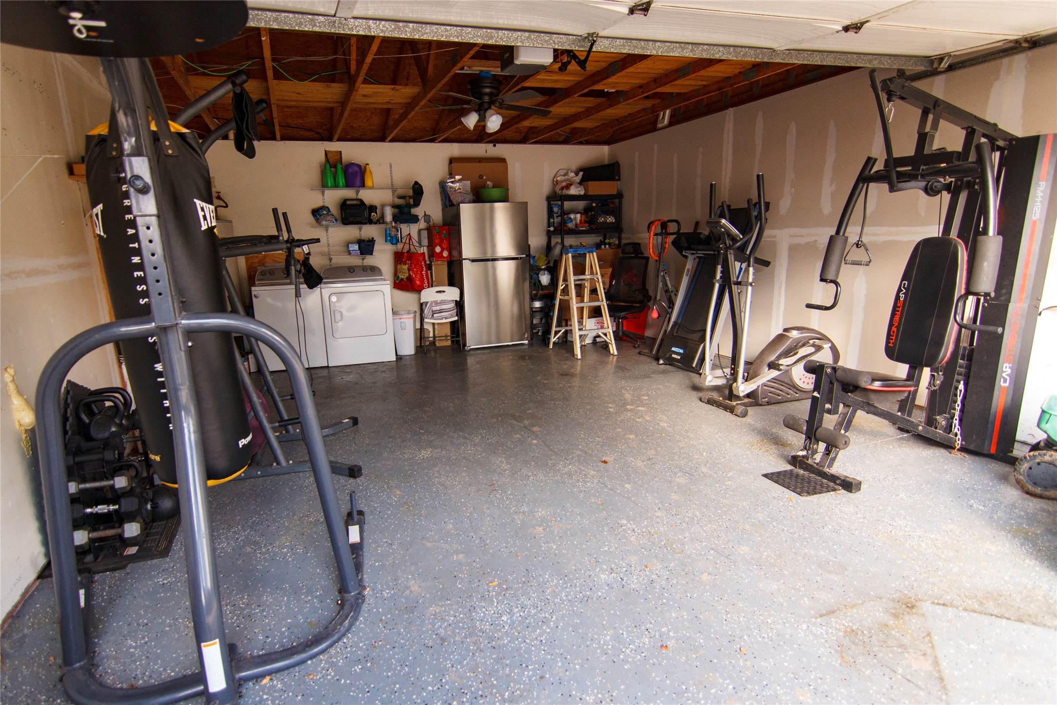 200 Keanahalululu Lane, Unit R Bastrop, TX 78602 - Photo 19 of 32 Workout area featuring a garage and washer and dryer