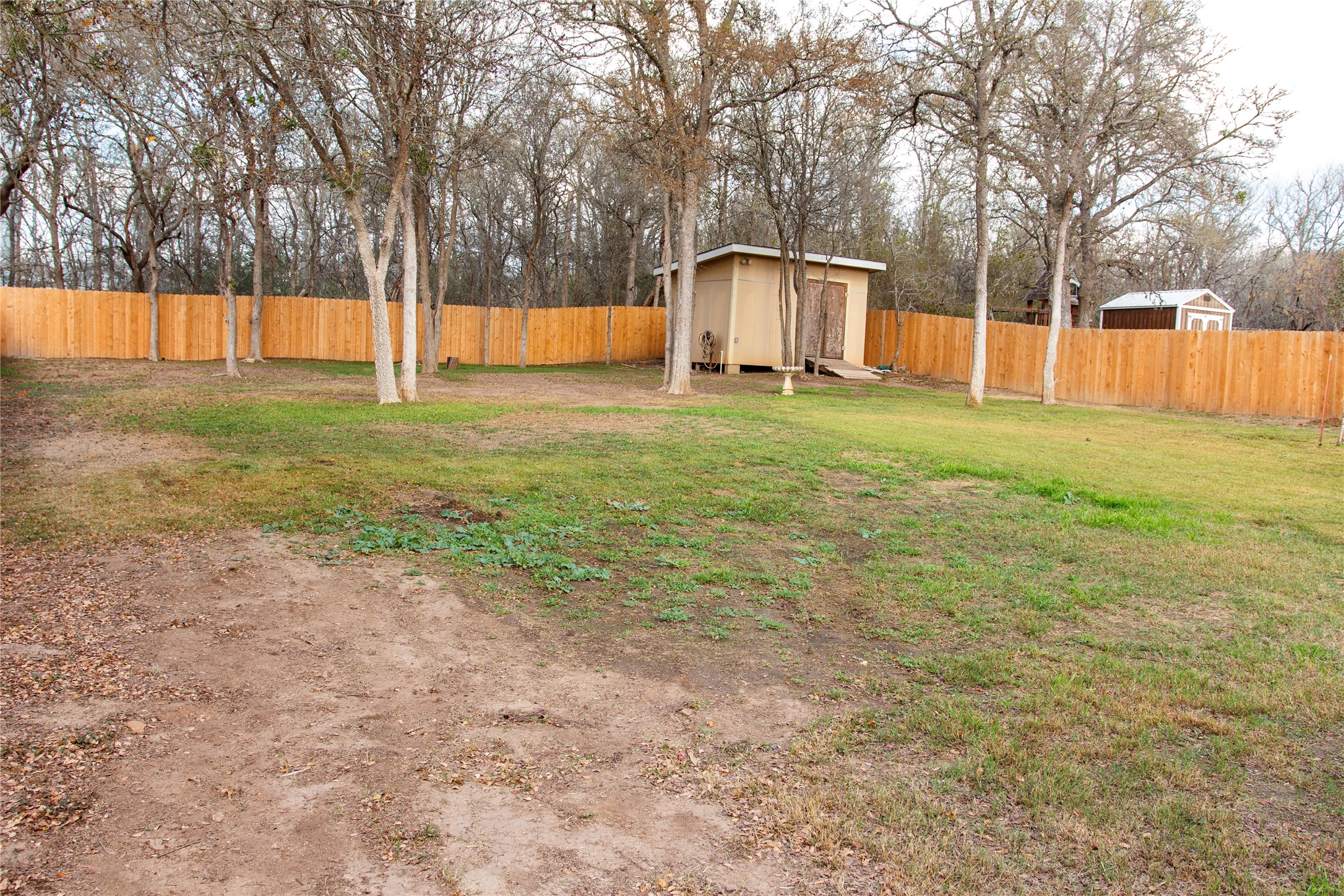 200 Keanahalululu Lane, Unit R Bastrop, TX 78602 - Photo 21 of 32 Fenced backyard featuring an outbuilding