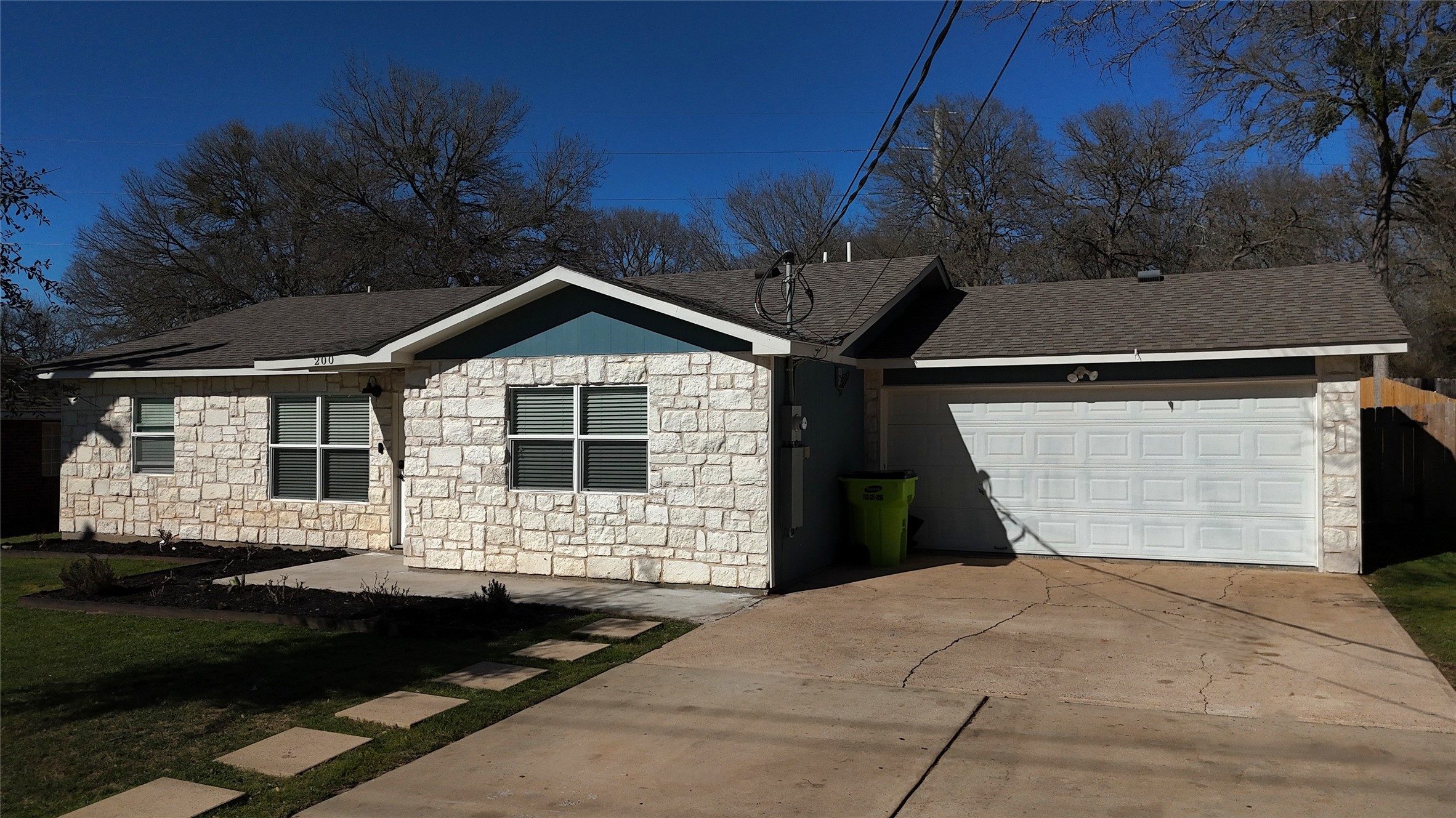 200 Keanahalululu Lane, Unit R Bastrop, TX 78602 - Photo 3 of 32 a front view of a house with a yard