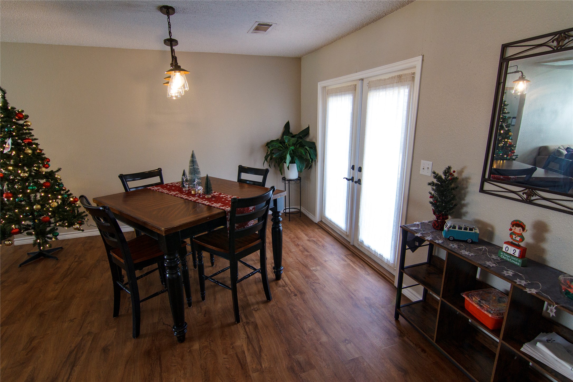 200 Keanahalululu Lane, Unit R Bastrop, TX 78602 - Photo 7 of 32 a view of a dining room with furniture and wooden floor