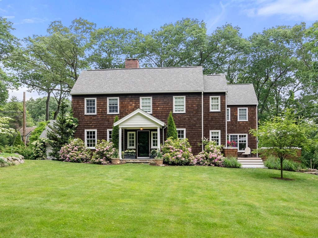 21 Hilltop Road Weston, MA 02493 - Photo 1 of 42 a front view of a house with garden