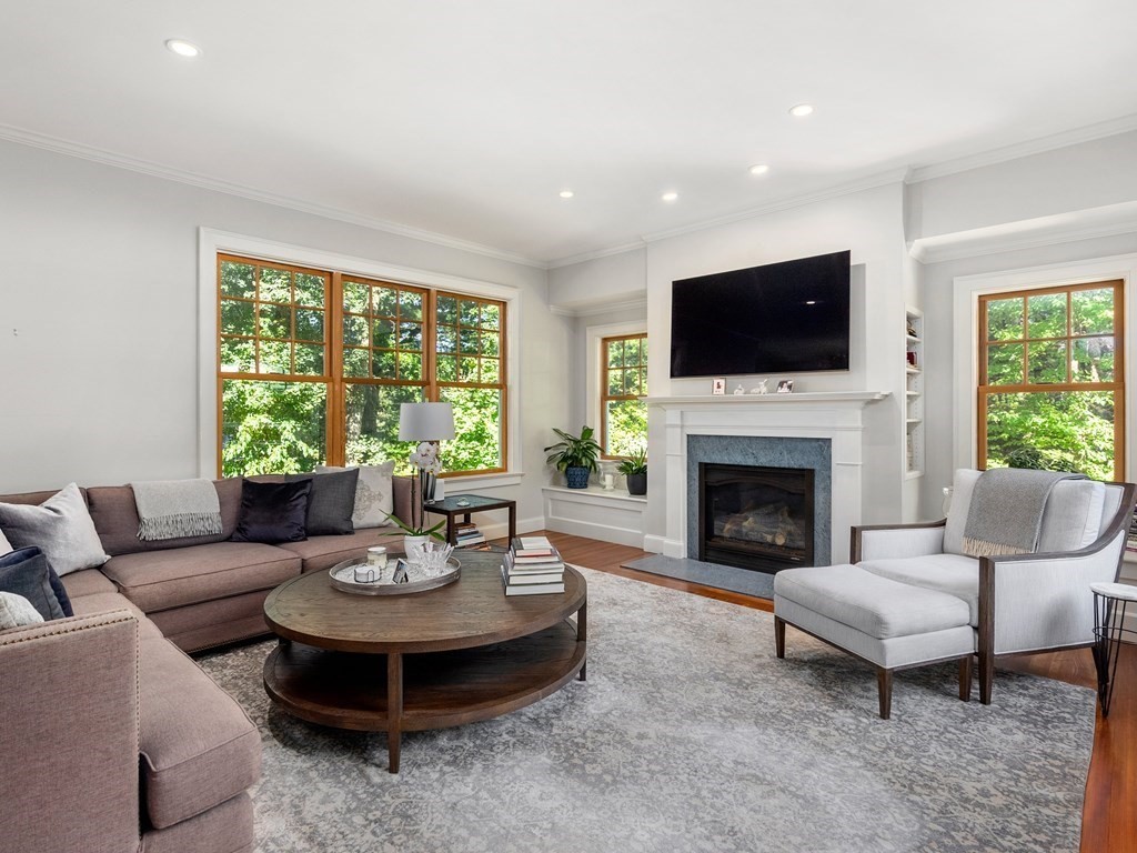 21 Hilltop Road Weston, MA 02493 - Photo 12 of 42 a living room with furniture a fireplace and a flat screen tv