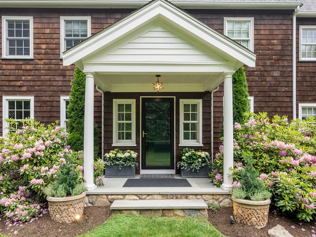 21 Hilltop Road Weston, MA 02493 - Photo 2 of 42 a view of a house with potted plants and a potted plant