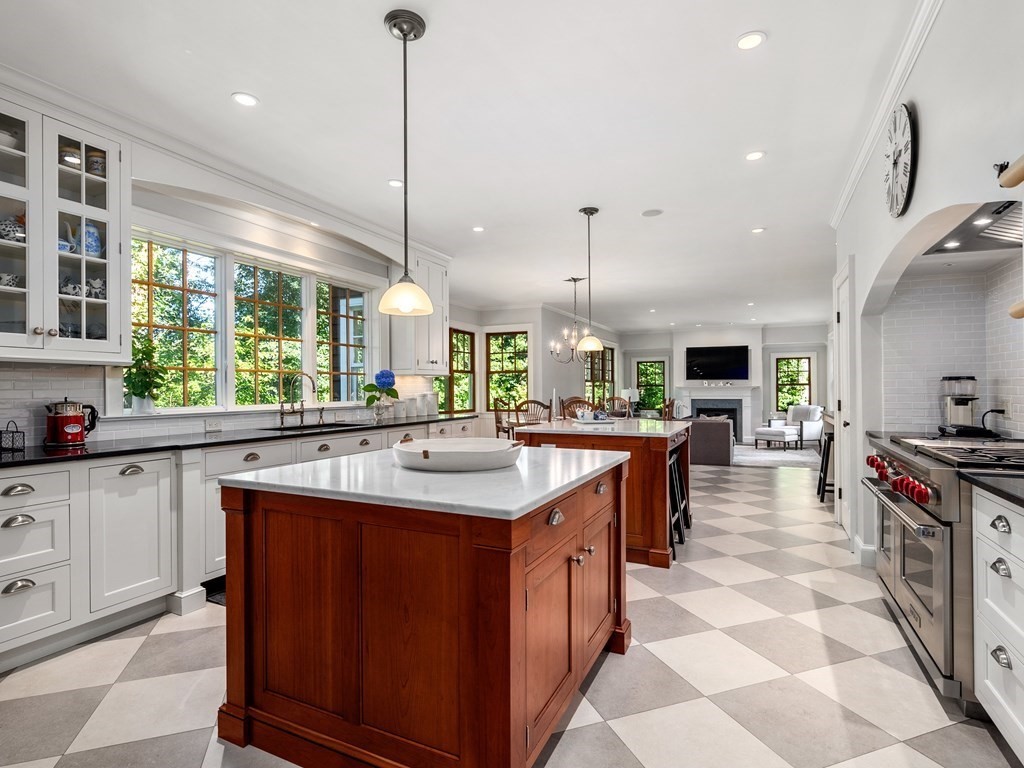 21 Hilltop Road Weston, MA 02493 - Photo 22 of 42 a kitchen with kitchen island a sink a counter top space appliances and a window