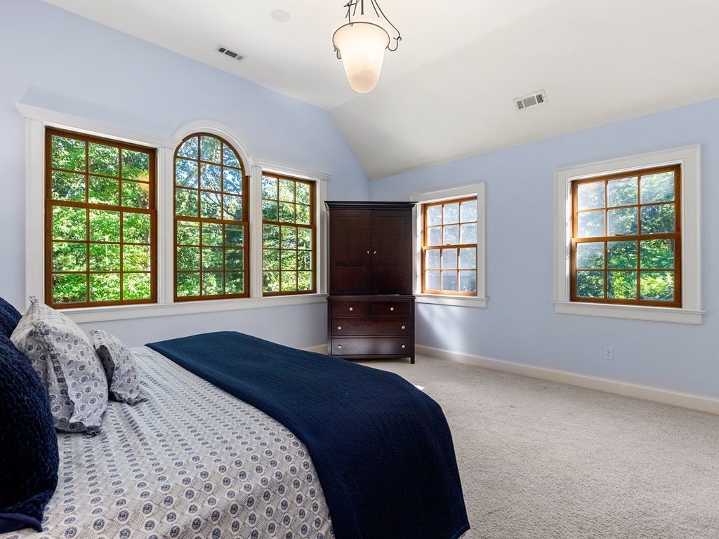 21 Hilltop Road Weston, MA 02493 - Photo 26 of 42 a bedroom with a large bed and a large window