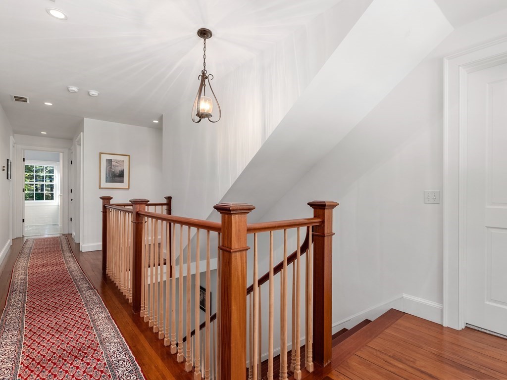 21 Hilltop Road Weston, MA 02493 - Photo 28 of 42 a view of a hallway with wooden floor and stairs