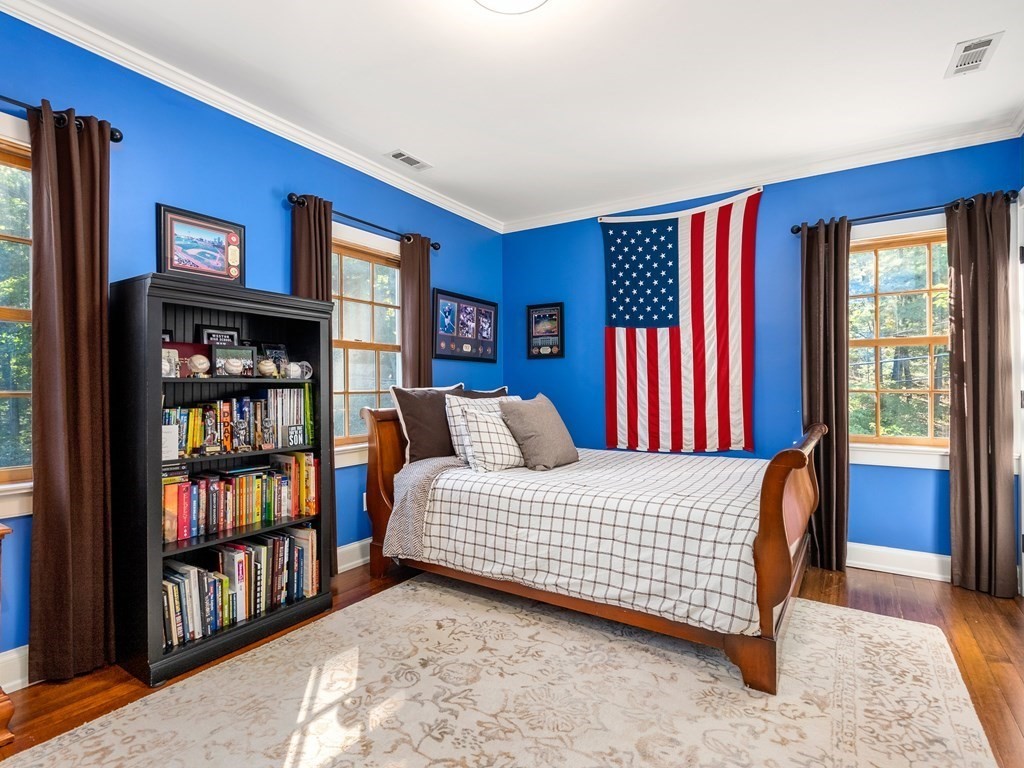21 Hilltop Road Weston, MA 02493 - Photo 31 of 42 a bedroom with a bed furniture and a book shelf