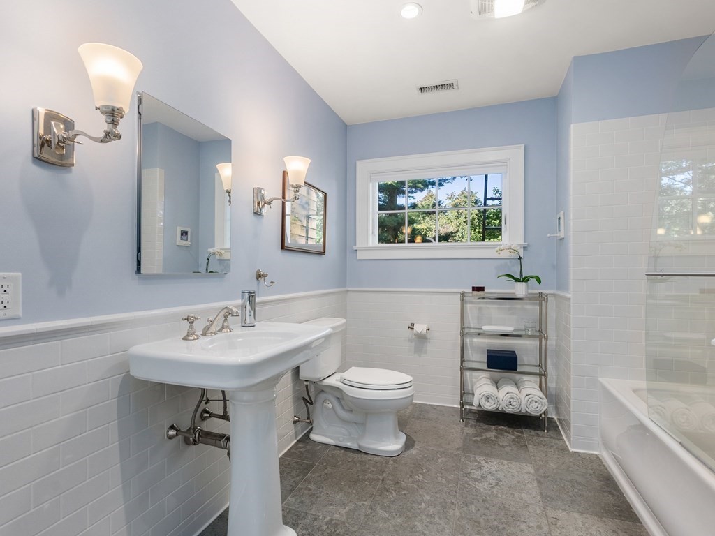 21 Hilltop Road Weston, MA 02493 - Photo 32 of 42 a bathroom with a toilet sink and mirror
