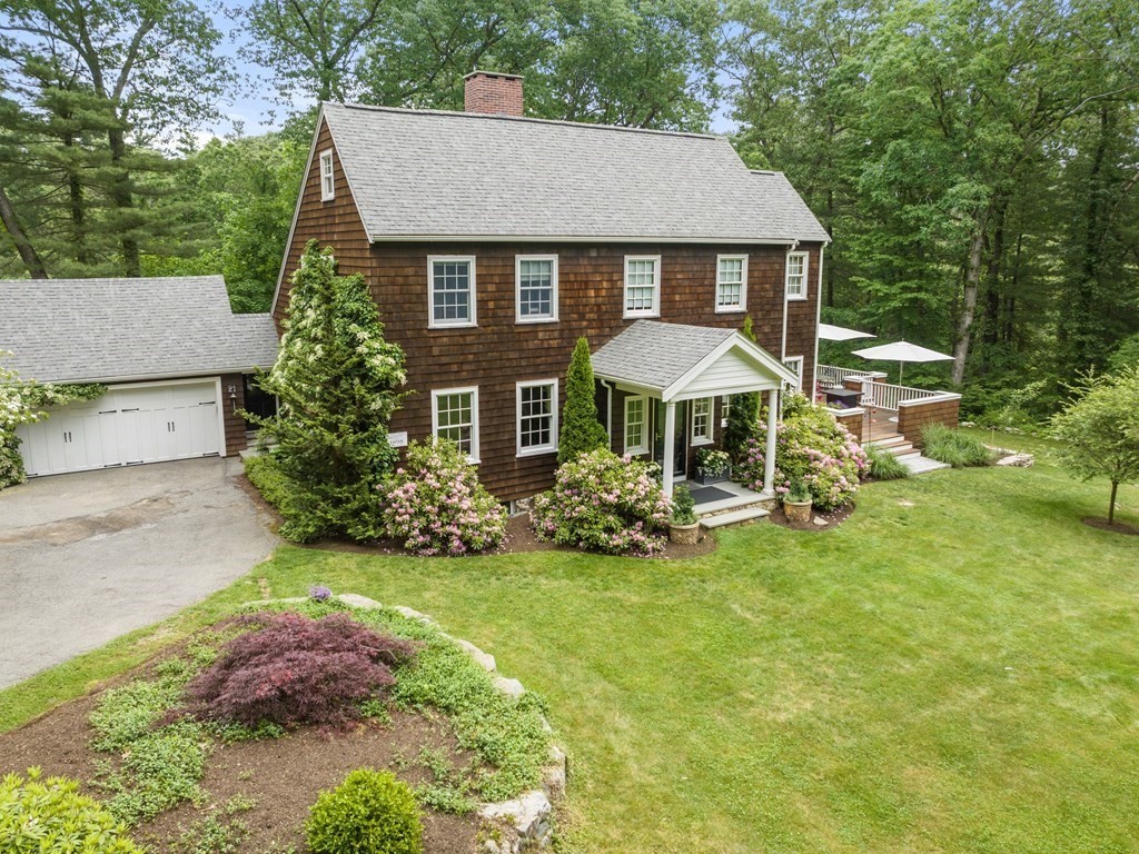 21 Hilltop Road Weston, MA 02493 - Photo 40 of 42 a front view of a house with a garden and porch