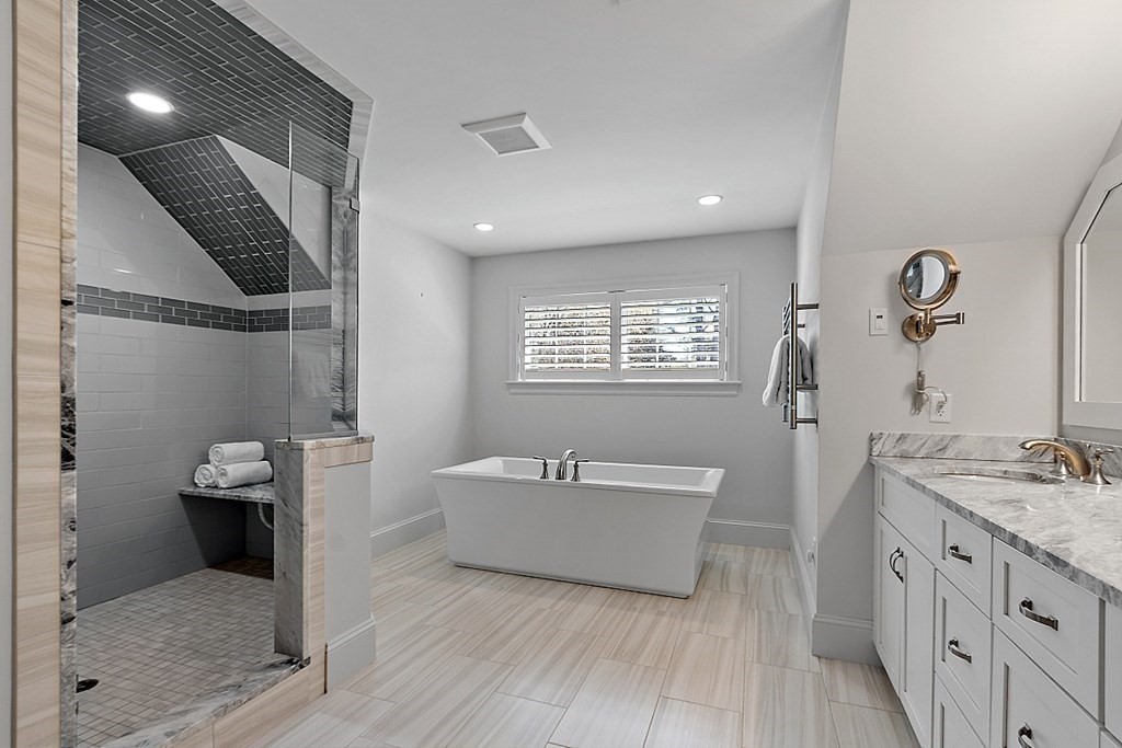 66 Oxbow Road Concord, MA 01742 - Photo 16 of 34 a spacious bathroom with a double vanity sink a mirror and a bathtub