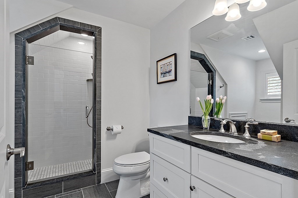 66 Oxbow Road Concord, MA 01742 - Photo 19 of 34 a bathroom with a granite countertop sink a toilet and shower