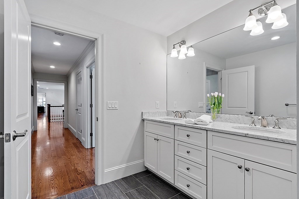66 Oxbow Road Concord, MA 01742 - Photo 21 of 34 a bathroom with a double vanity sink and a mirror