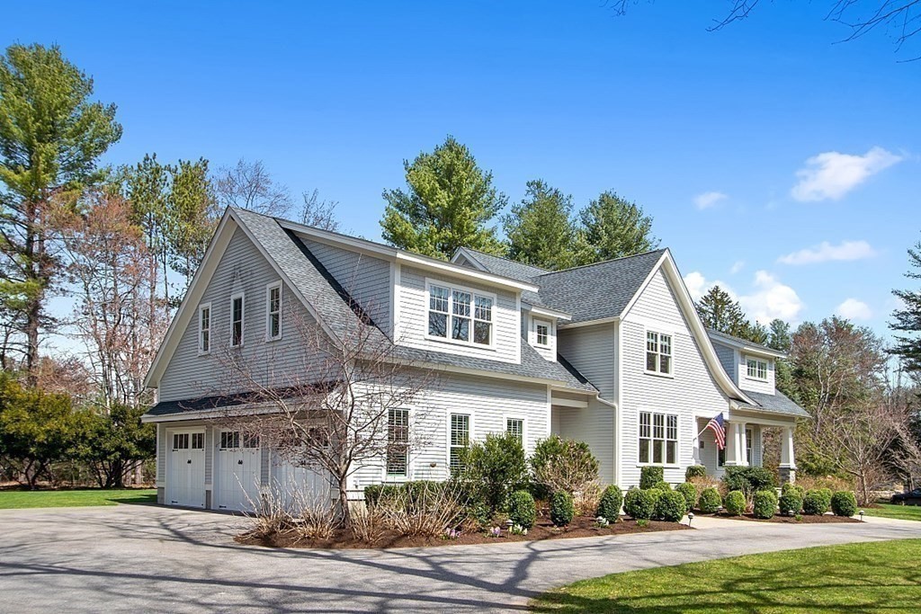 66 Oxbow Road Concord, MA 01742 - Photo 28 of 34 a front view of a house with a garden and tree