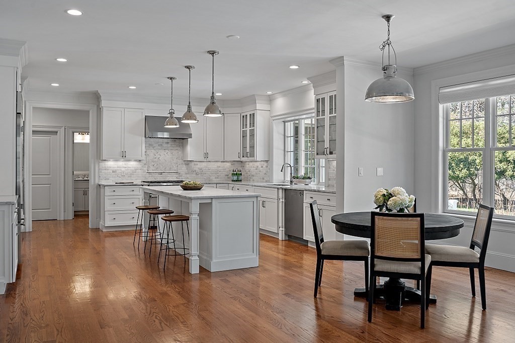 66 Oxbow Road Concord, MA 01742 - Photo 4 of 34 a kitchen with stainless steel appliances kitchen island granite countertop a table chairs and a refrigerator