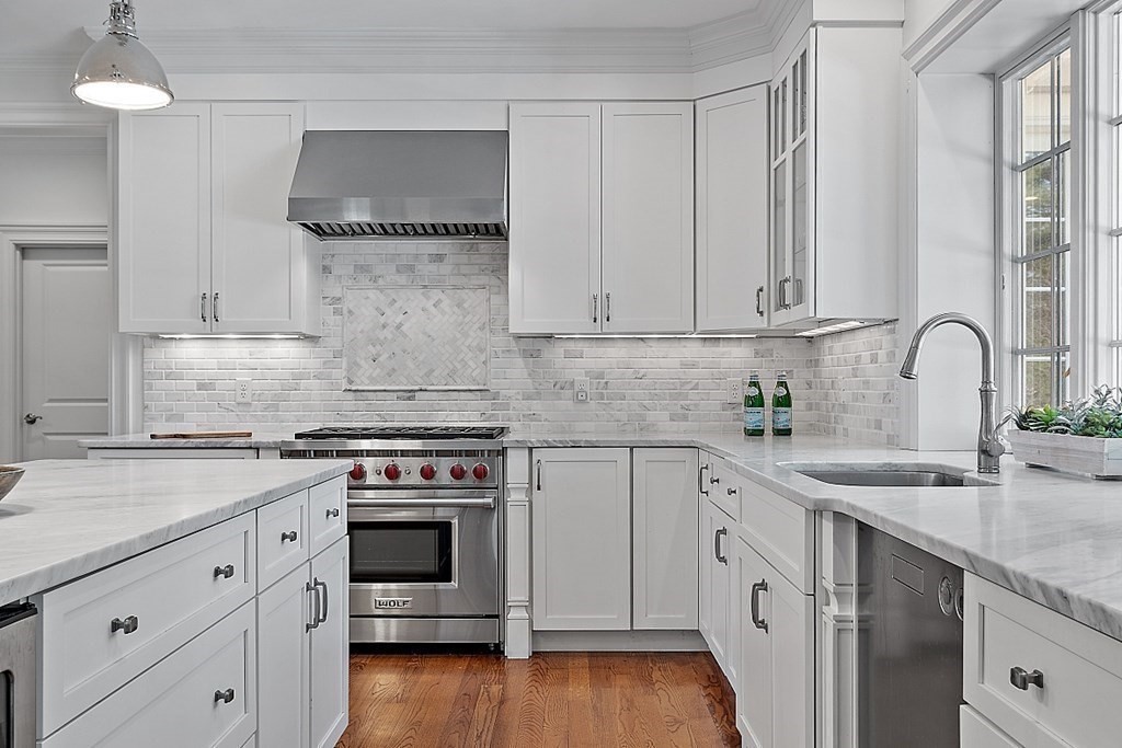 66 Oxbow Road Concord, MA 01742 - Photo 6 of 34 a kitchen with granite countertop a stove a sink and wooden floor