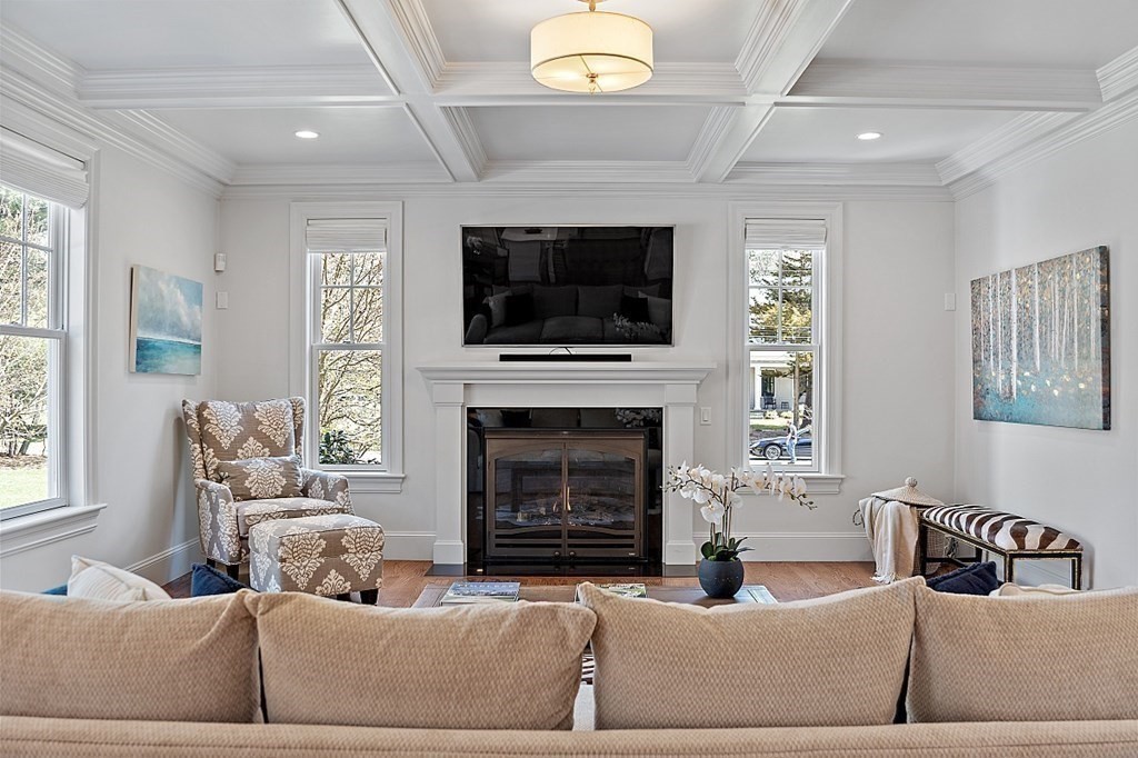 66 Oxbow Road Concord, MA 01742 - Photo 9 of 34 a living room with furniture a flat screen tv and a fireplace