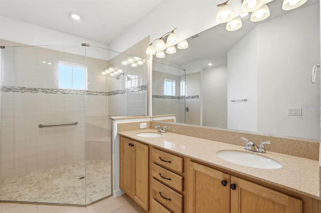 10374 Southwest 96th Street Ocala, FL 34481 - Photo 19 of 29 a bathroom with a sink shower and a mirror