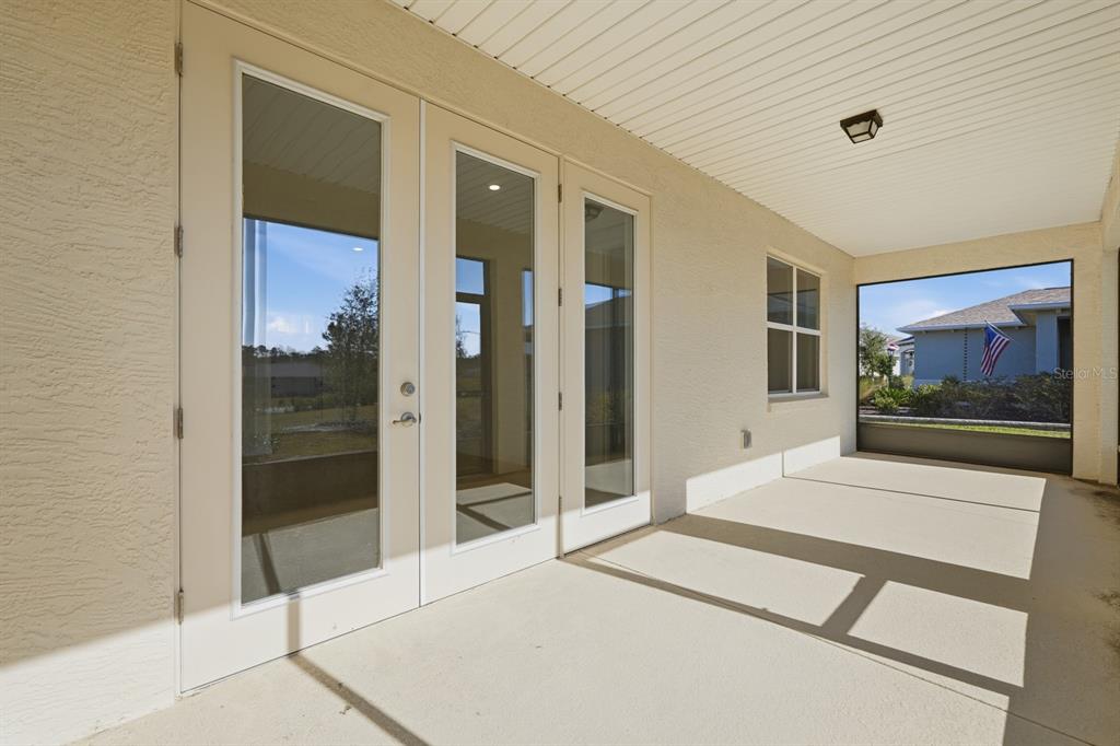 10374 Southwest 96th Street Ocala, FL 34481 - Photo 21 of 29 a room with a large mirror next to a bathroom