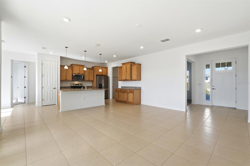 10374 Southwest 96th Street Ocala, FL 34481 - Photo 8 of 29 a view of a kitchen with a refrigerator and a stove top oven