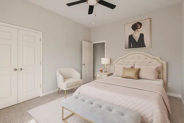 a bedroom with a bed and a chair