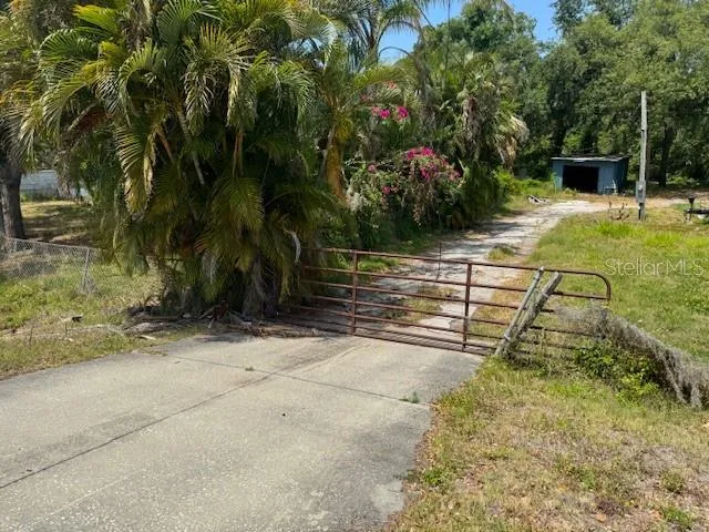 a view of backyard with swimming pool and seating area